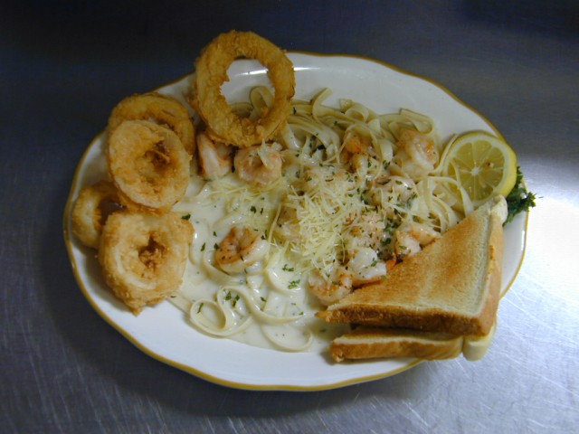 Shrimp Fettuccini Alfredo with Onion Rings. Salad Bar included of Captain Joe's Seafood, Brunswick, Georgia